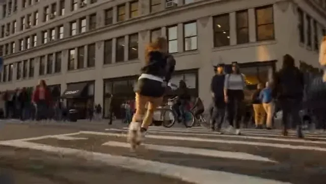 A young woman roller skating at high speed through a vibrant, bustling city street during golden hour, with motion blur and dynamic lighting.