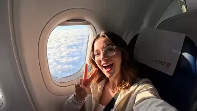 A traveler taking a selfie with a famous world landmark in the background, with a fast-paced montage effect.