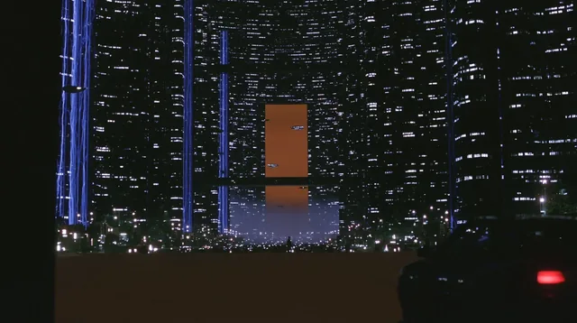 A sprawling futuristic city with towering skyscrapers and bright neon signs.