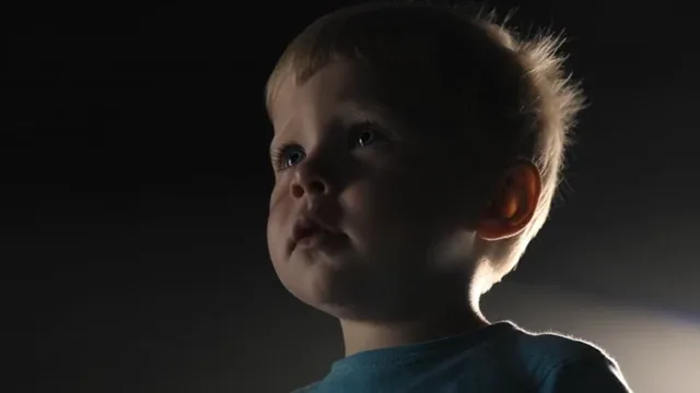 Two figures illuminated by spotlights on a dark stage, facing each other in a tense confrontation.