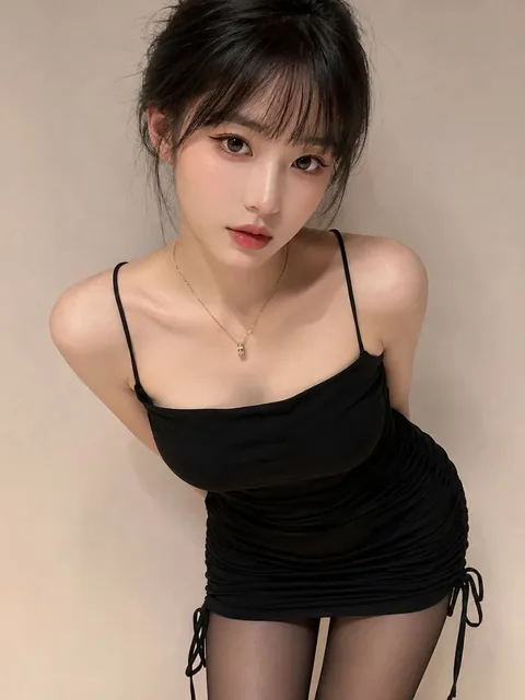A half-body portrait of a beautiful Chinese woman with bangs and a neat bun, wearing a black slip mini dress and sheer stockings, leaning towards the camera with a soft, warm lighting.