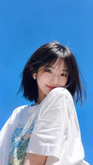 Ultra-realistic low-angle wide-angle shot of a cheerful young woman with fair skin and black hair, wearing a white graphic tee and silver necklace, holding a transparent cup of iced orange juice with a smiling face logo, against a clear blue sky.