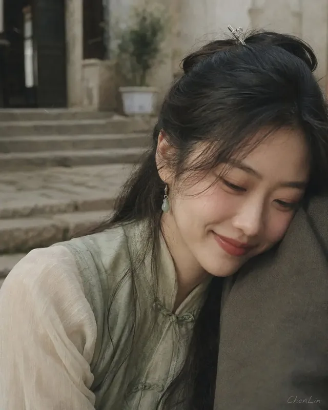 A close-up, shallow depth of field film photograph of a young East Asian woman with dark hair, wearing a traditional-style top. She is leaning her cheek gently against a shoulder, eyes closed or downcast, with soft, diffused light highlighting her features. The background is a blurred courtyard setting.