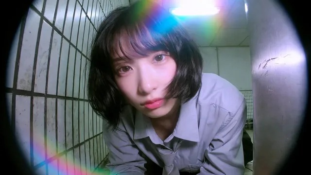 A mid-20s Japanese or Korean woman in a collared shirt and necktie in a low prone pose, illuminated by neon light spill against a subway tile wall and metal column, captured with f