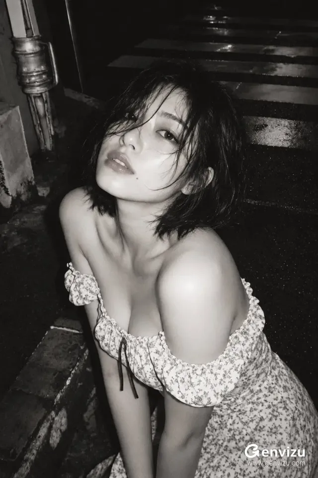 Monochrome high-angle portrait of a short-haired woman near stone steps under soft lighting.