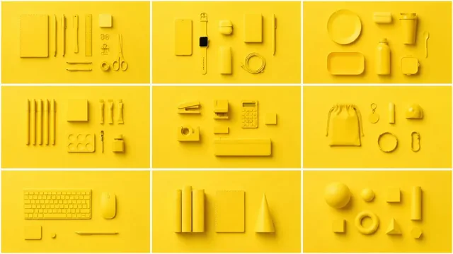 A minimalist flat lay arrangement of various yellow objects, including stationery and small gadgets, set against a matching yellow seamless backdrop with soft shadows and high nega