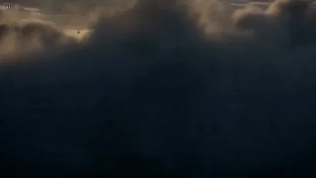 A giant, translucent whale glowing gold and blue swims through storm clouds above mountain peaks, with airships following and the word 'MORNING' in the sky.
